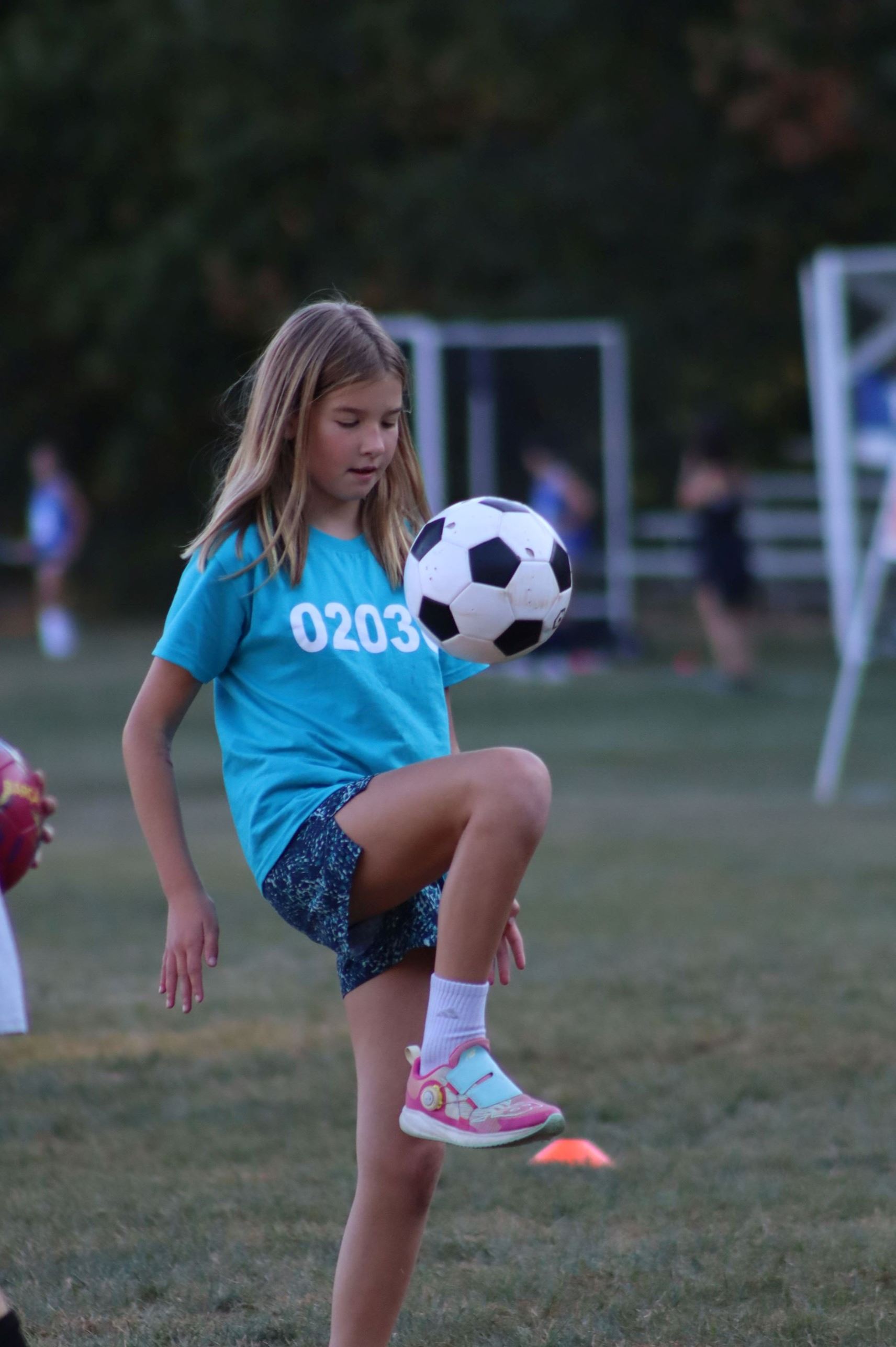 Photo of girl juggling soccer ball