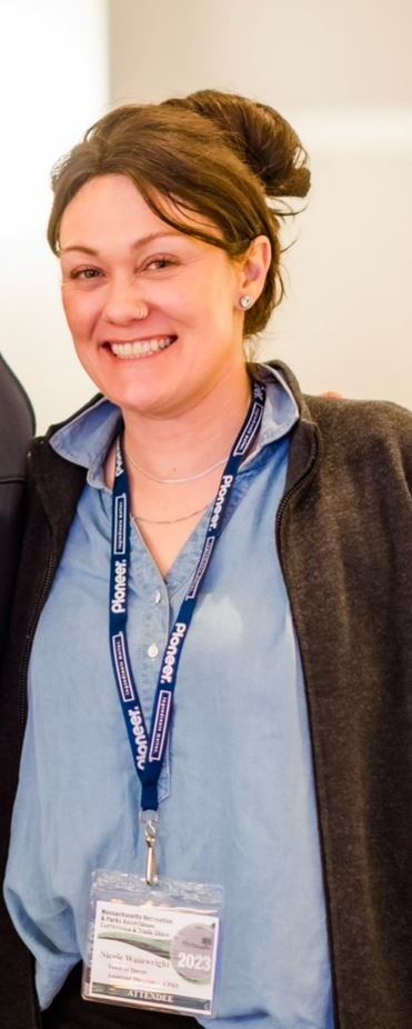 photo of brown haired woman wearing a lanyard